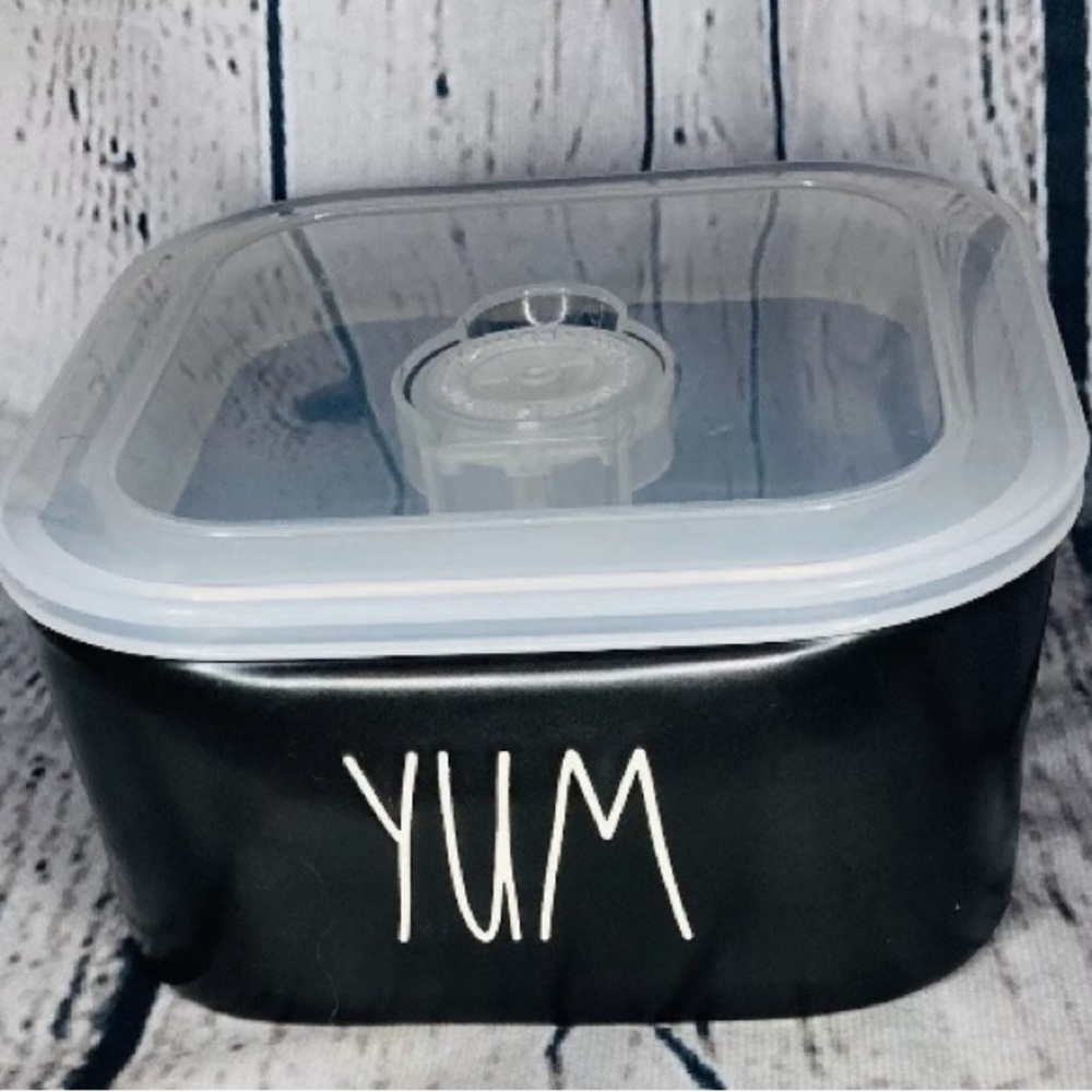 Rae Dunn portable food container with lid. Says Yum on front.